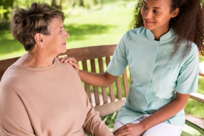 caregiver smiling at the elder